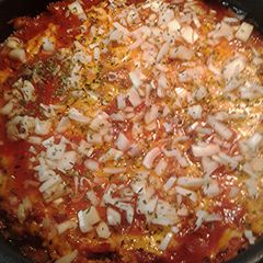 A picture of Chili cheese dog with the works casserole.