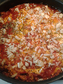 A picture of Chili cheese dog with the works casserole.