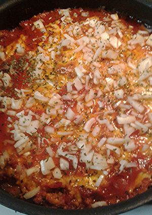 A picture of Chili cheese dog with the works casserole.