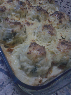 A picture of Potato Balls with Chicken and White Sauce.