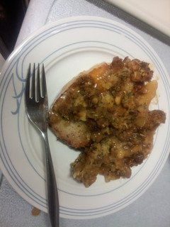 A picture of Pork chops with apples and stuffing.
