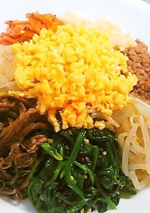 A picture of 8 Namul Bibimbap with Lots of Vegetables.