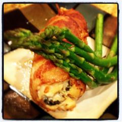 A picture of bacon wrapped chicken breast stuffed with cheese.