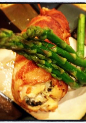 A picture of bacon wrapped chicken breast stuffed with cheese.