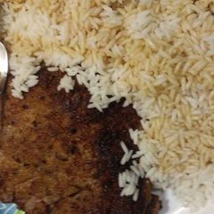 A picture of Breaded steak and rice.