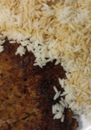 A picture of Breaded steak and rice.