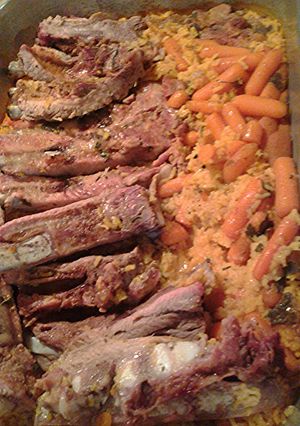 A picture of Ribs and carrots on rice.