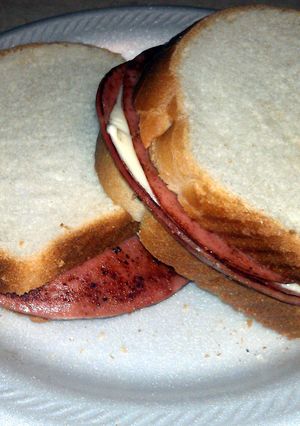 A picture of fried bologna and cheese sandwich.
