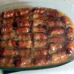 A picture of bacon wrapped smokies with butter and brown sugar.