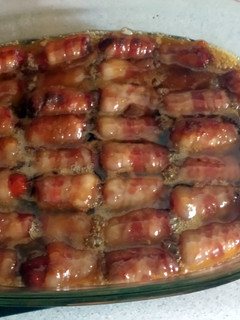 A picture of bacon wrapped smokies with butter and brown sugar.