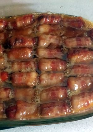 A picture of bacon wrapped smokies with butter and brown sugar.