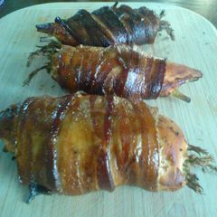 A picture of Smoked Stuffed Chicked with Asparagus Wrapped in Bacon.