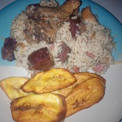 A picture of Coconut rice,assorted beef and chicken with plantain.