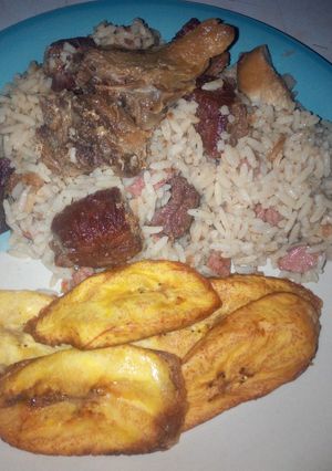 A picture of Coconut rice,assorted beef and chicken with plantain.