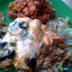 A picture of Chicken Enchiladas Spanish Rice Fried Cabbage.