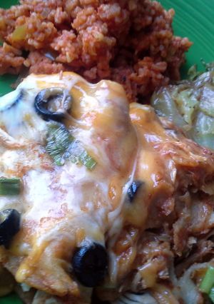 A picture of Chicken Enchiladas Spanish Rice Fried Cabbage.