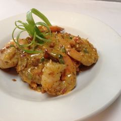 A picture of shrimp and grits with chorizo cream sauce.