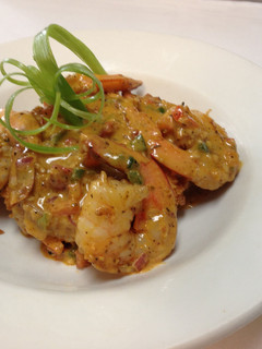 A picture of shrimp and grits with chorizo cream sauce.