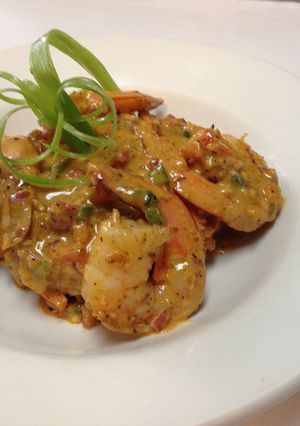 A picture of shrimp and grits with chorizo cream sauce.