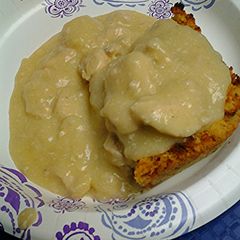 A picture of Cornbread dressing with chicken gravy.