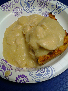 A picture of Cornbread dressing with chicken gravy.
