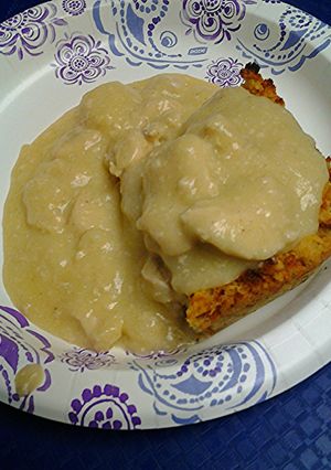 A picture of Cornbread dressing with chicken gravy.