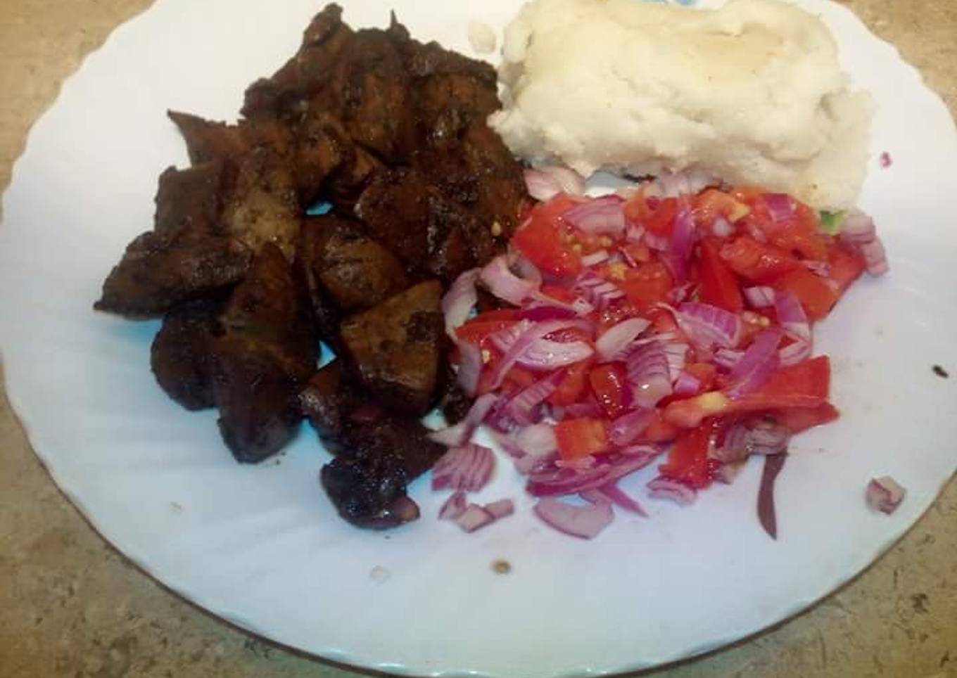 Deep fried pork with Kachumbari and Ugali