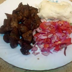 Deep fried pork with Kachumbari and Ugali A picture of Deep fried pork with Kachumbari and Ugali.