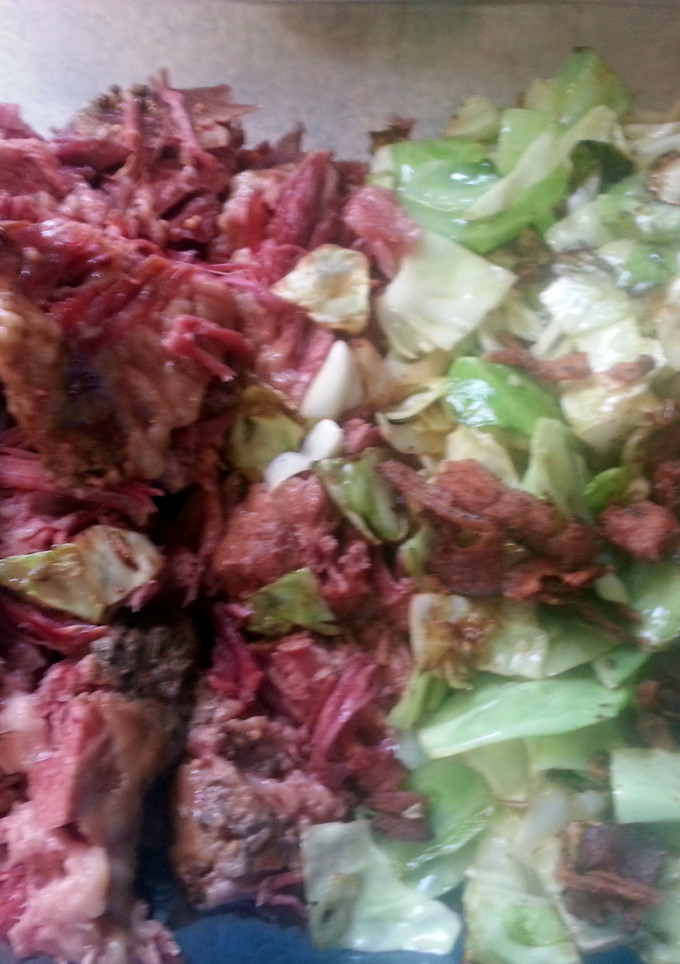 A picture of Corned beef and fried cabbage with bacon.