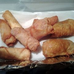 A picture of New Years appetizers pizza eggrolls, pizza wontons ,calzzones jalapeño popper eggrolls and wontons.