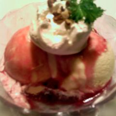 A picture of pomegranate syrup on ice cream.