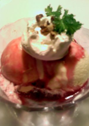 A picture of pomegranate syrup on ice cream.
