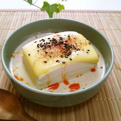 A picture of Warm Tofu with Soy Milk and Melting Cheese.