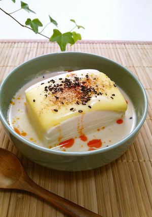 A picture of Warm Tofu with Soy Milk and Melting Cheese.