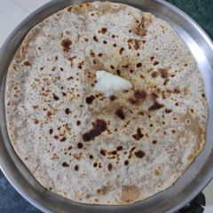 A picture of Tilgul poli - sesame and jaggery roti.