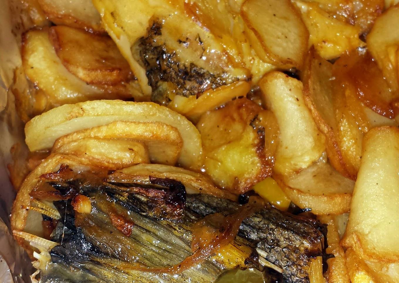 Fried cod and potatoes in olive oil