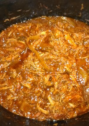 A picture of Pulled BBQ pork in a crock pot.