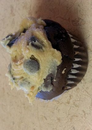 A picture of caramel chocolate cupcakes with cookie dough frosting.