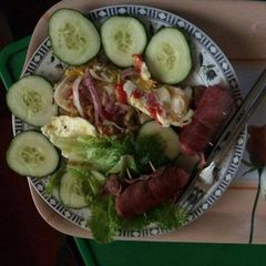 A picture of Fried egg with sausage,cucumber and lettuce.