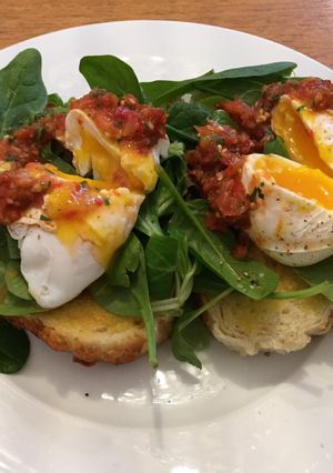 A picture of Poached eggs and tomato salsa.