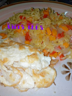 A picture of Noodles with fried egg.