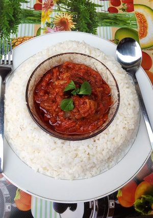 A picture of Boiled rice and tomato stew.