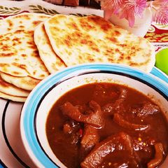 A picture of Pita bread with pepper soup of ganda.