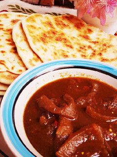 A picture of Pita bread with pepper soup of ganda.