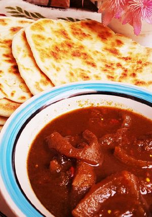 A picture of Pita bread with pepper soup of ganda.