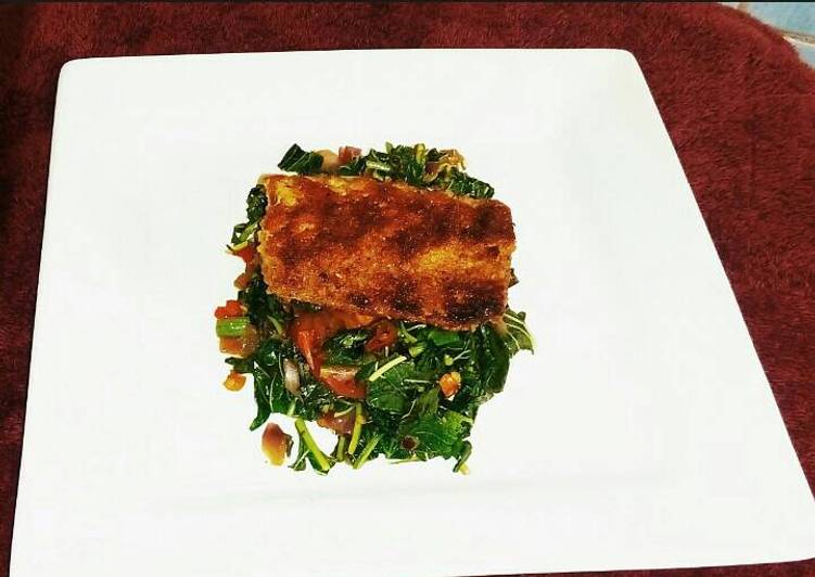 Grilled breaded Fish filet on a bed of Blanched Spinach