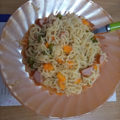 A picture of Veggie Indomie and sausage.