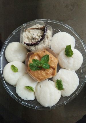 A picture of Baby idlis with coconut chutney and onion tomato chutney.