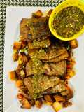 Beef steak with chimichuri sauce and stir fried apple and vegetables