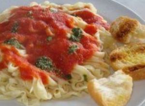 Una foto de Fettuccine con crema jamón y salsa de tomate